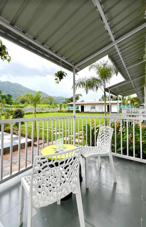 a patio with a table and chairs on a porch at zoz 3p1 in Anantnāg