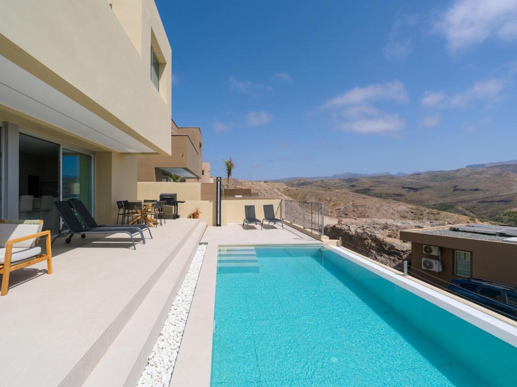 a swimming pool on the balcony of a house at Salobre Golf Villas Kaiman in Salobre