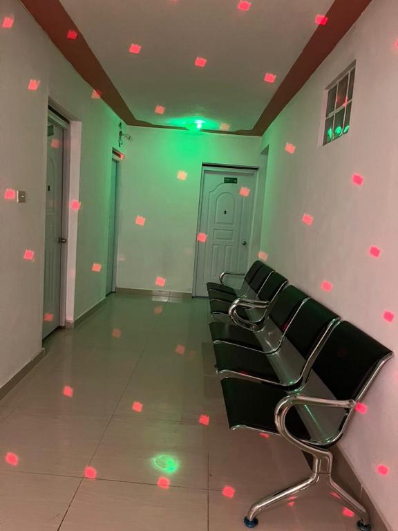 a row of chairs in a room with green walls at BaYO HOTEL in Vaudreuil