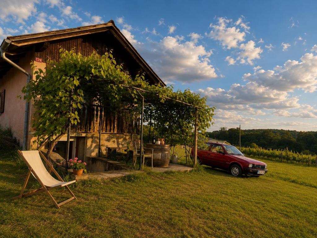 a red car parked in front of a house at Weekendica in Fokovci