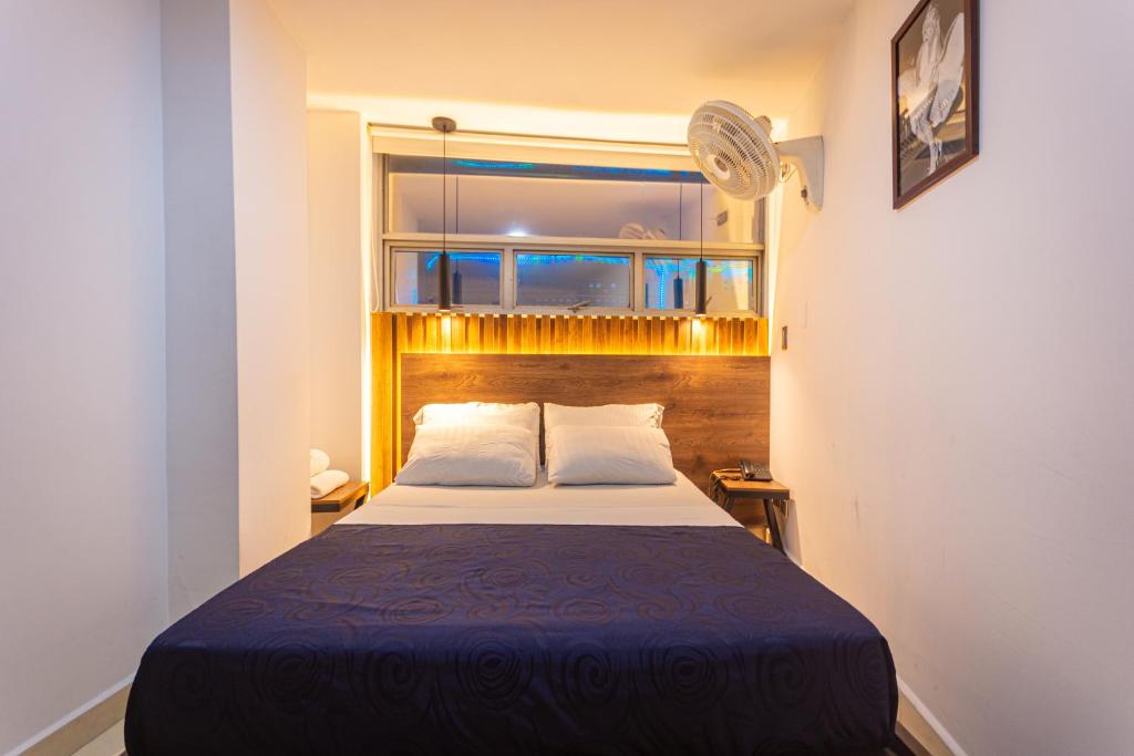 a bedroom with a large bed in a room with a window at Hotel Los Angeles Bello in Bello
