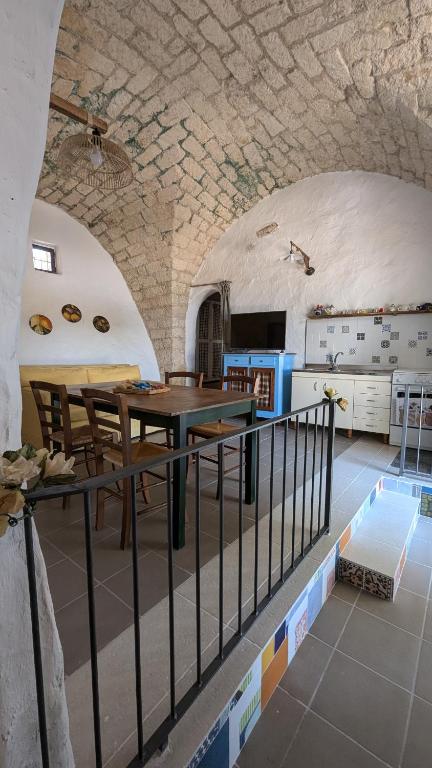 a room with a table and chairs in a building at Masseria Mustazzo in Siponto
