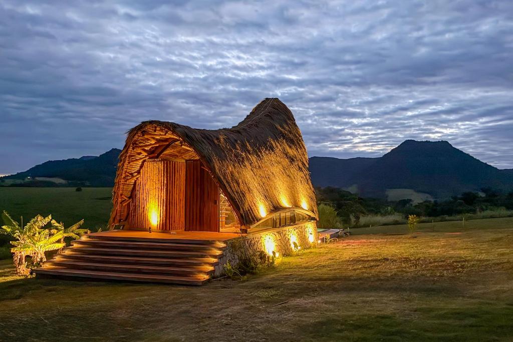 a log house with lights on it in a field at Viento Blanco in Independencia