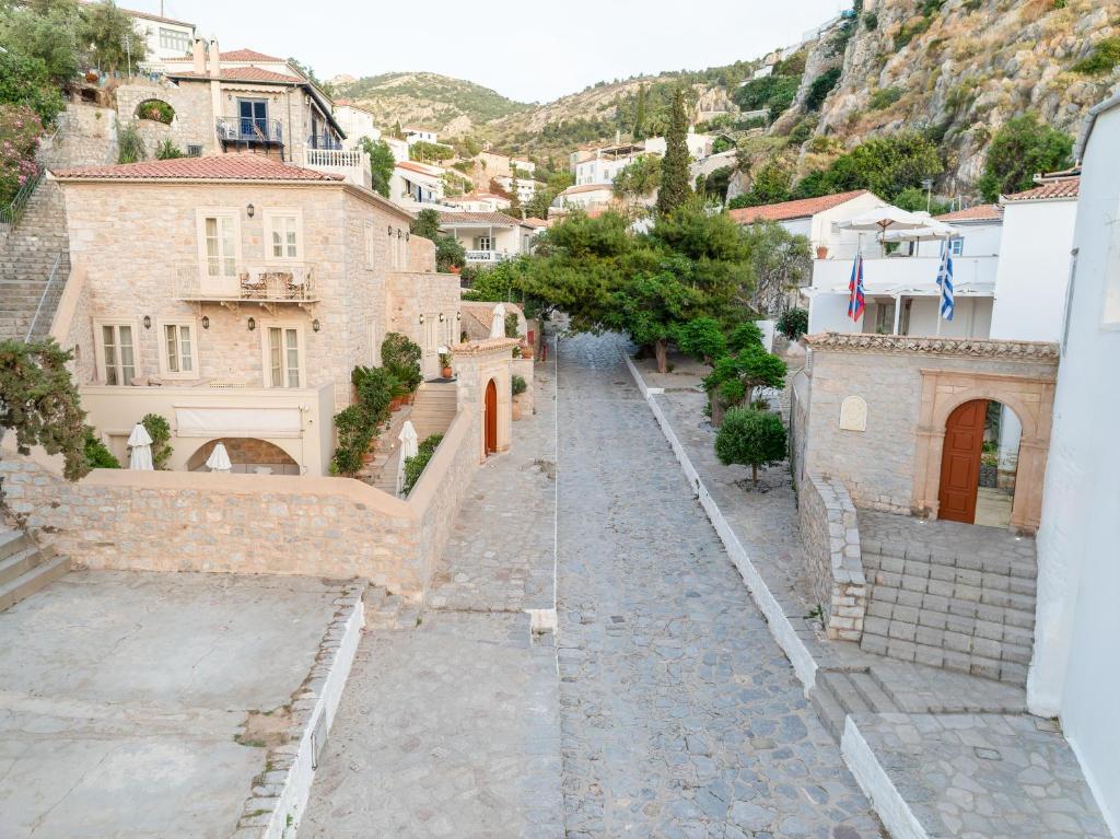 a cobblestone street in a village with buildings at Angelica Traditional Boutique Hotel in Hydra