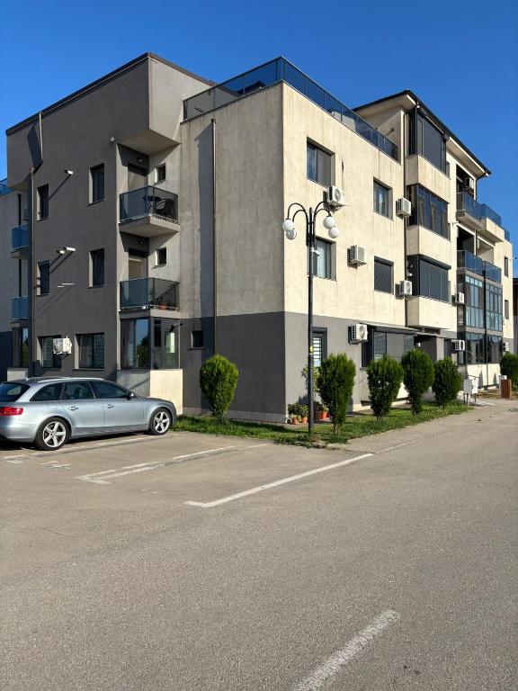 a car parked in a parking lot in front of a building at SeaEsta Studio in Agigea