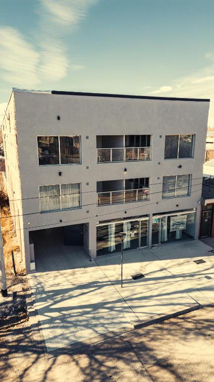 a large white building with a lot of windows at uriburu45 in Malargüe