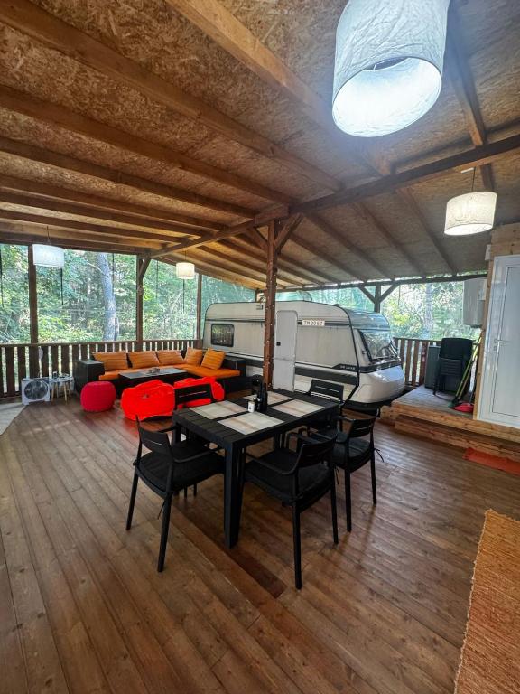 a living room with a table and chairs and an rv at karavana.ta in Chernomorets