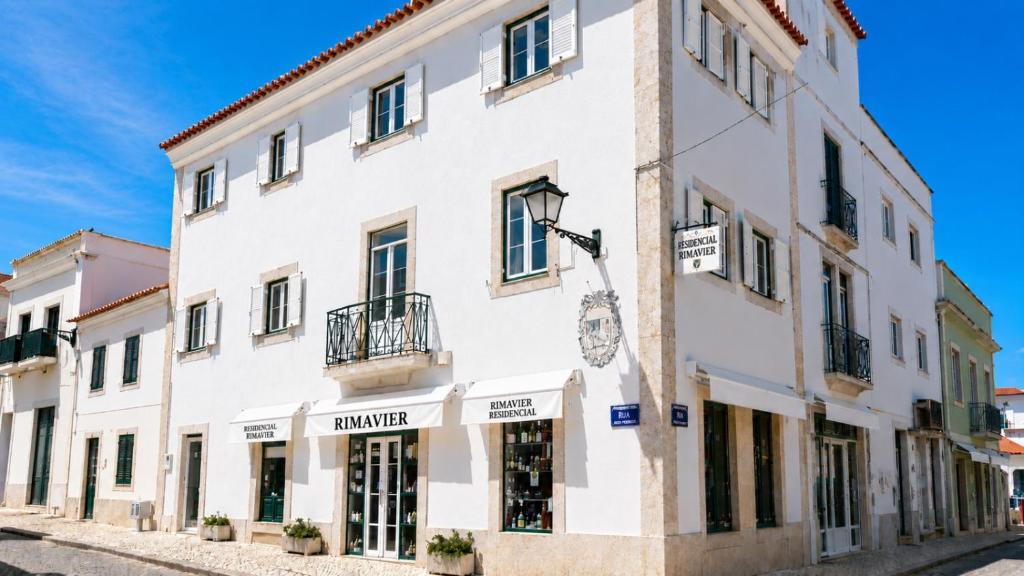 a white building on the side of a street at Rimavier Residence in Peniche