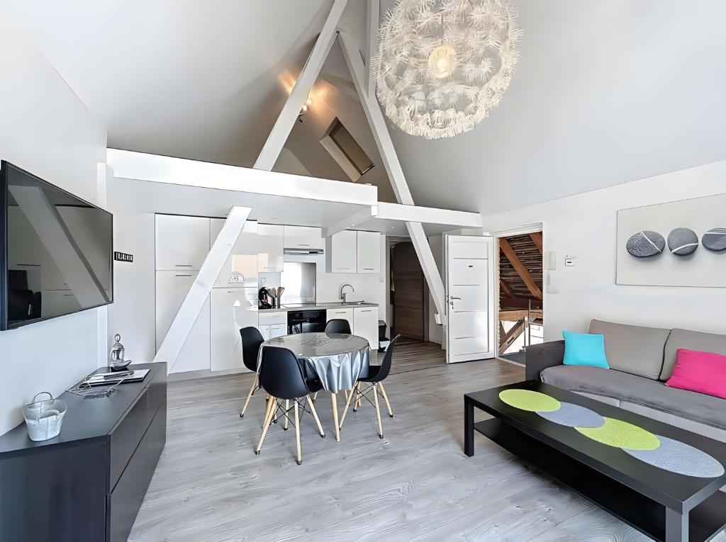 a living room with a couch and a table at Gite Donald proche Colmar in Ingersheim