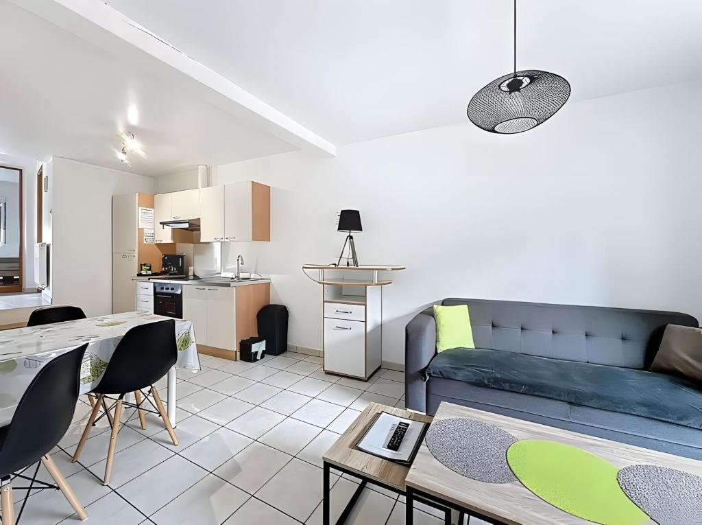 a living room with a couch and a table at Gite Marie proche Colmar in Ingersheim