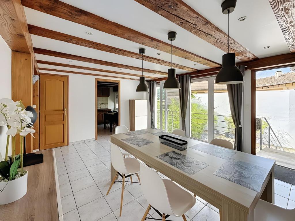 a kitchen with a large table and white chairs at Gite Loan proche Colmar in Ingersheim