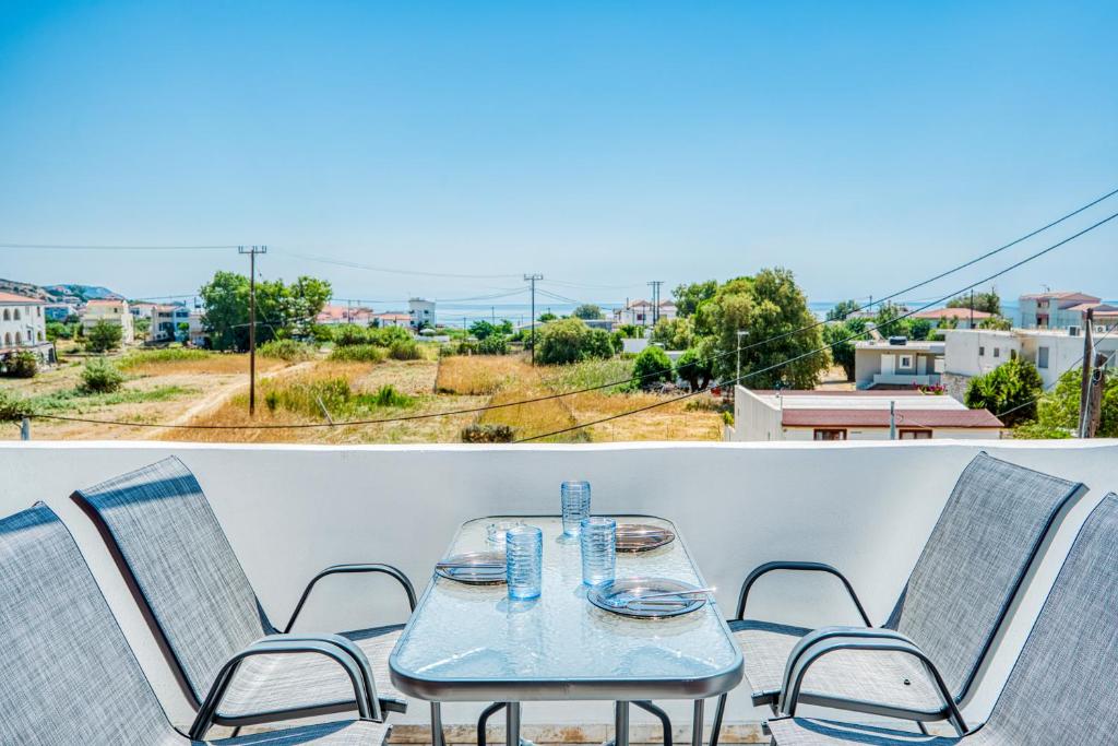 a table and chairs on a balcony with a view at Vergici Apartment 1 in Kómi