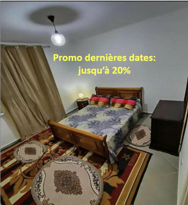a bedroom with a bed and a rug at Béjaïa 7 Jolis grands Apparts F3-F2 49-69e in Bejaïa