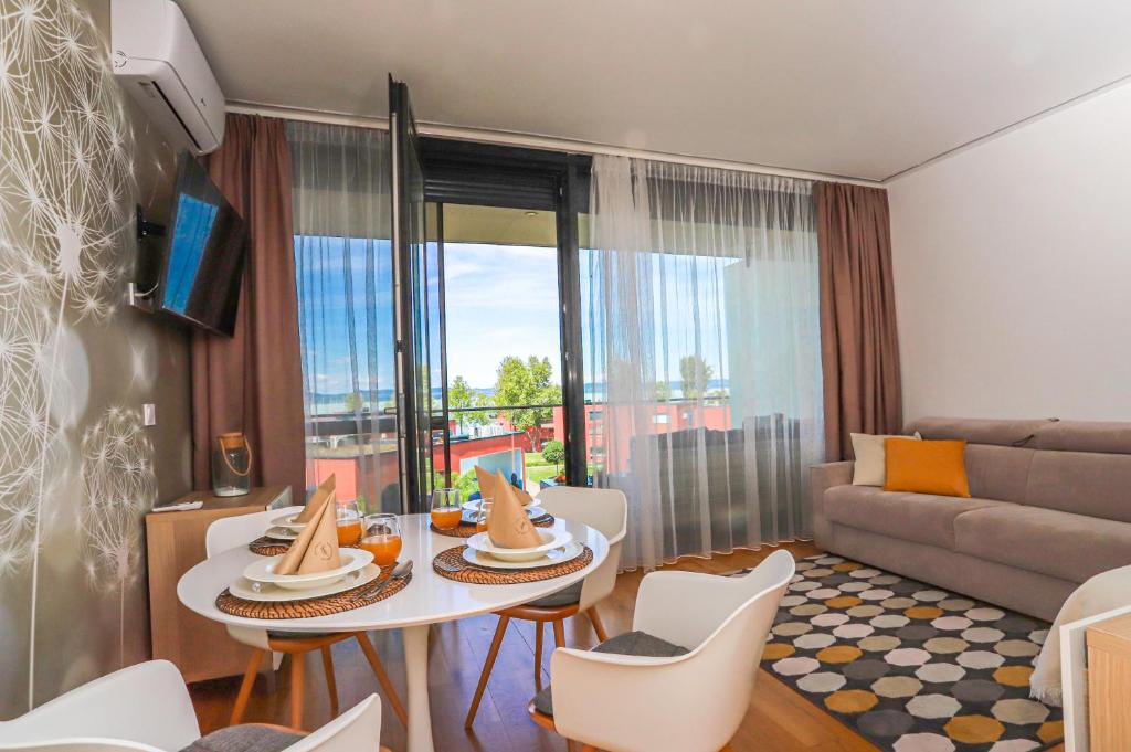 a living room with a table and chairs and a couch at BL Waterside 55 in Balatonlelle