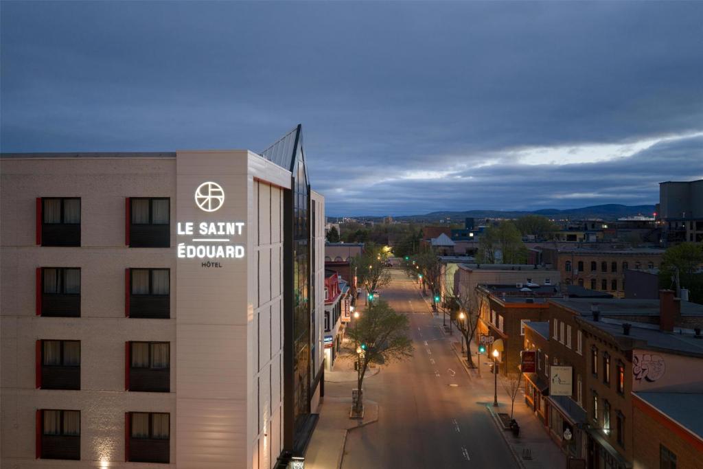 a building with a sign on it on a city street at Le Saint Edouard, WorldHotels Distinctive in Quebec City