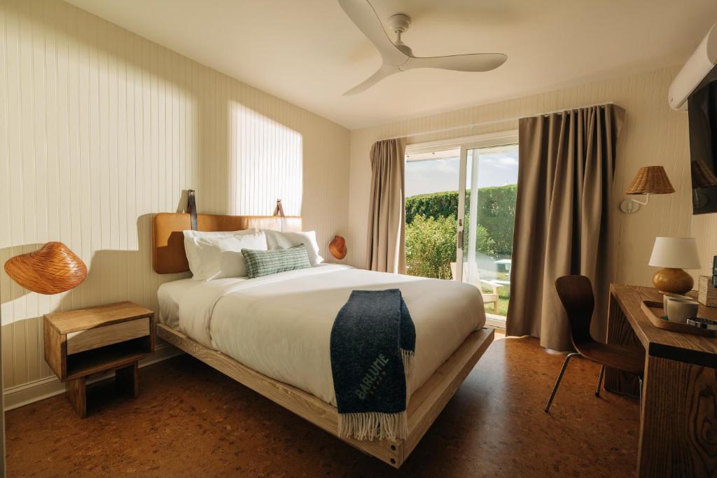 a bedroom with a large bed and a window at Barlume Beach in Montauk