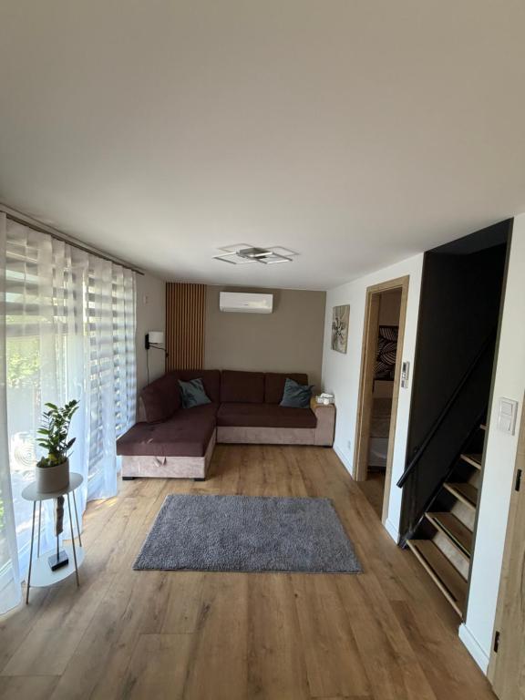 a living room with a couch and a tv at Harmat Apartman Hajdúnánás in Hajdúnánás