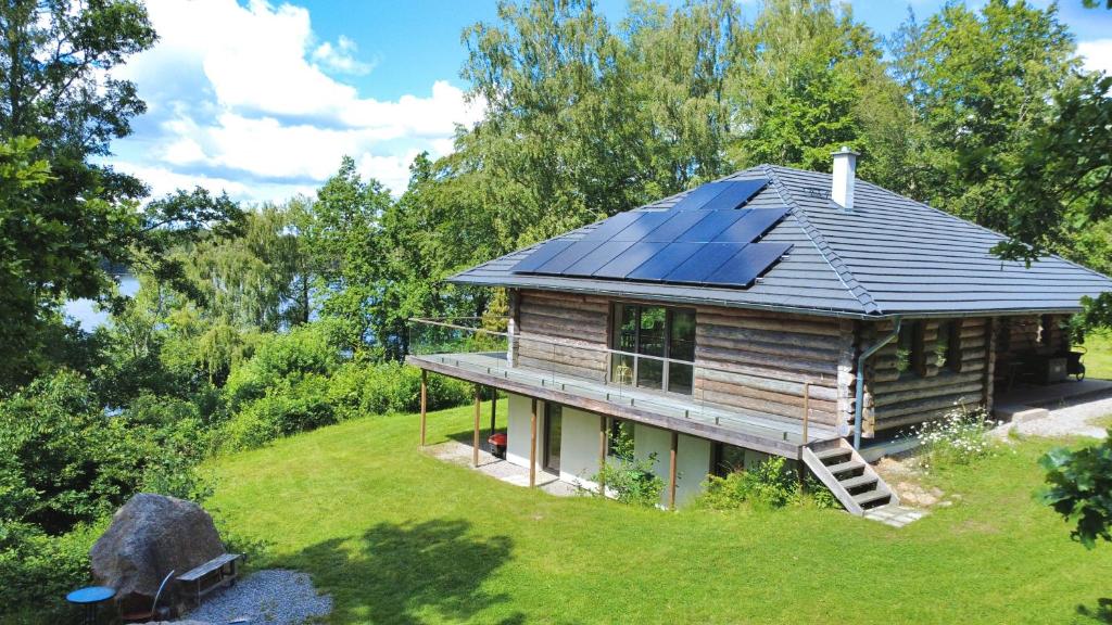 a house with solar panels on the roof at Villa Bergsmåla in Eringsboda