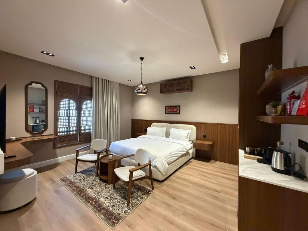 a bedroom with a bed and a table and chairs at Atrah Quiet Stylish Studio in Medina