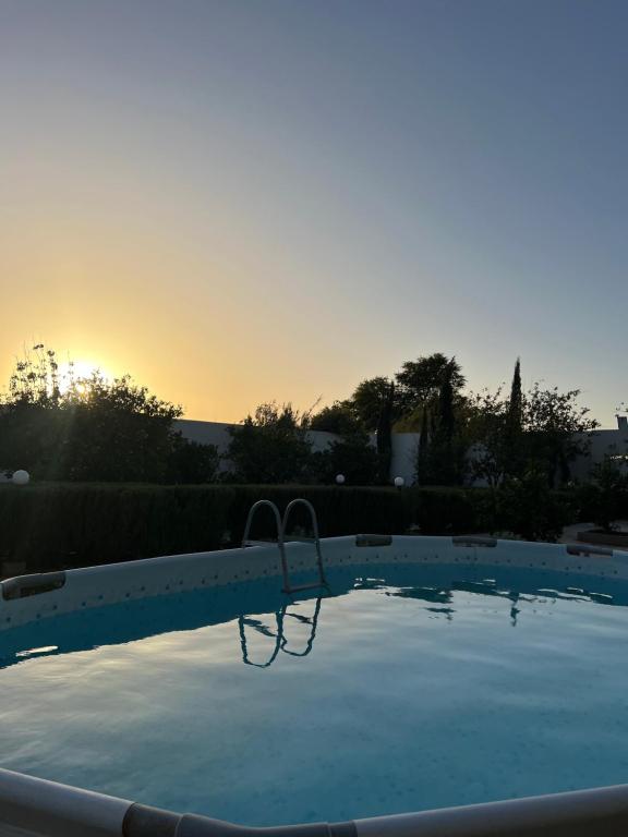 a swimming pool with a basketball hoop in the sunset at Safae in Agadir
