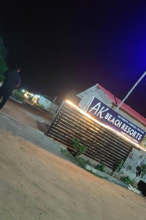 a man riding a skateboard in front of a hotel at night at Ak Green View Beach Resorts in Chīrāla