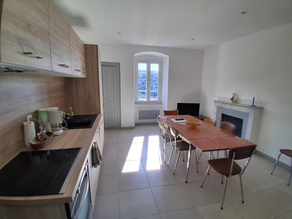 a kitchen with a table and a dining room at Santoni House in Ghisoni