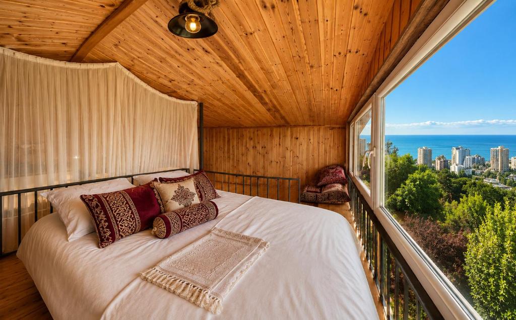 a bedroom with a bed on a balcony at Alis House 3 in Batumi