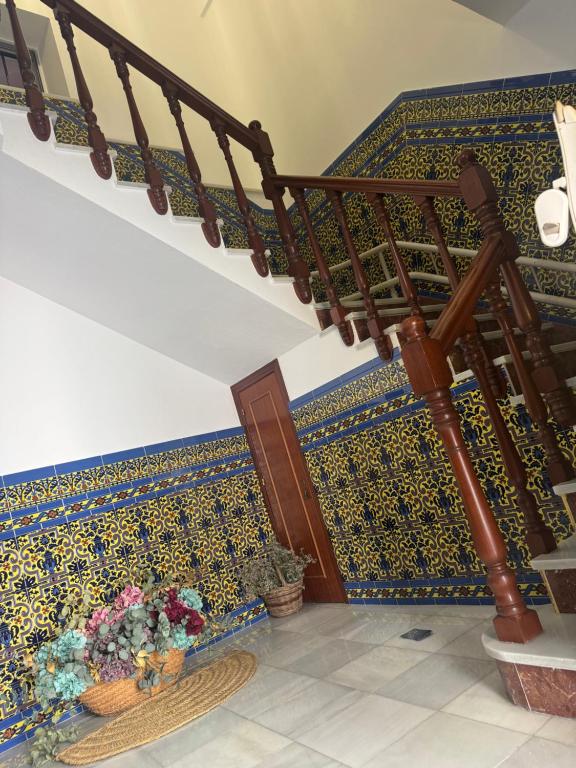 a staircase with a patterned wall and a stair case at CALIZA y LUZ in Arcos de la Frontera