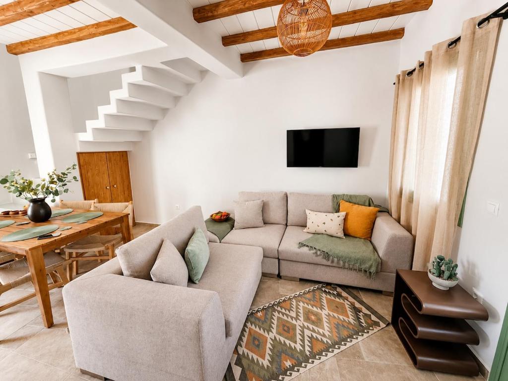 a living room with a couch and a table at Villa Sofia Traditional Cycladic living in Kampos Paros
