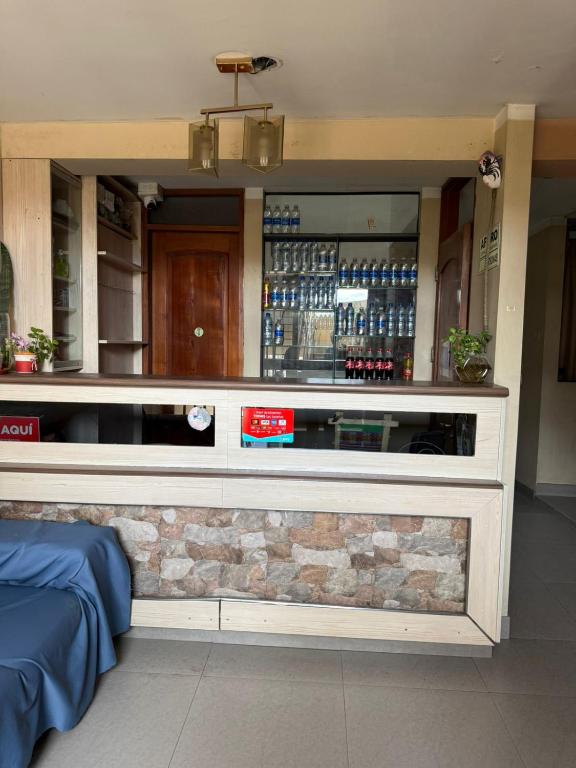 a bar in a restaurant with a stone wall at Hostal Tintaya in Cajamarca