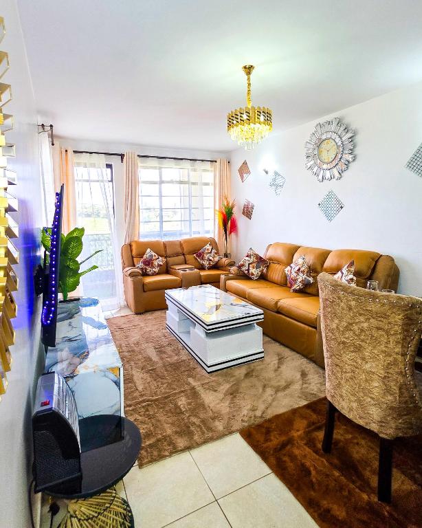 a living room with a couch and a coffee table at The Royals in Tatu City