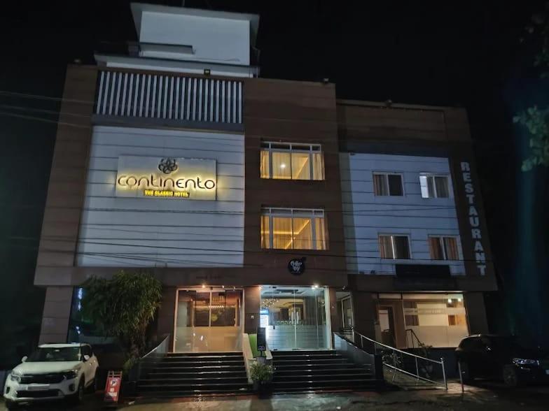 a building with a car parked in front of it at Continento the classic hotel in Malappuram