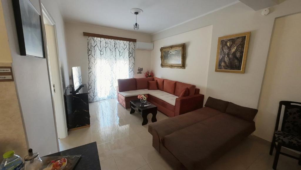a living room with a red couch and a table at Dream Home in Sparta