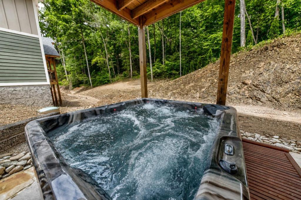 a hot tub in the backyard of a house at Break Time - Modern 5BR with hot tub, game room, air hockey and resort pool in Gatlinburg