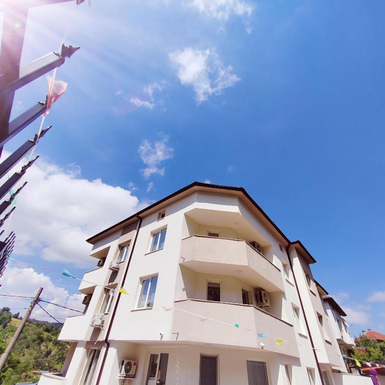 a white building with a star on top of it at Къща за гости КрисиЯна in Zlatograd