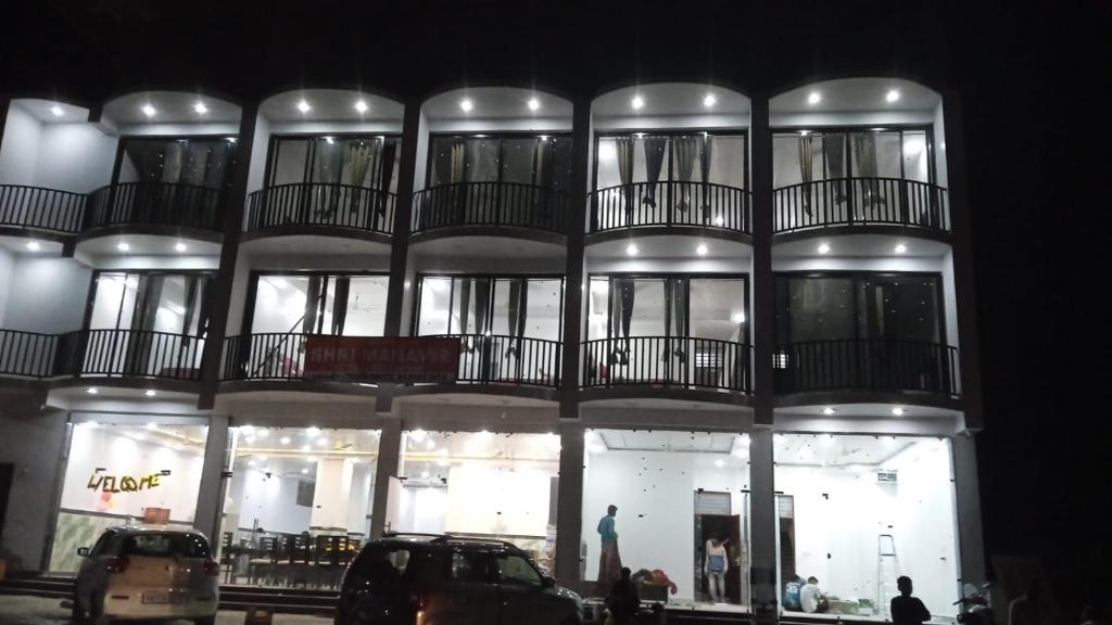 a large building with balconies on top of it at Hotel Shri Mahavir in Chamoli