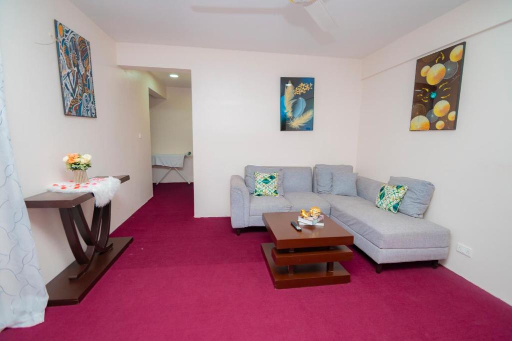 a living room with a couch and a table at Zanzibar Rahaa in Dar es Salaam