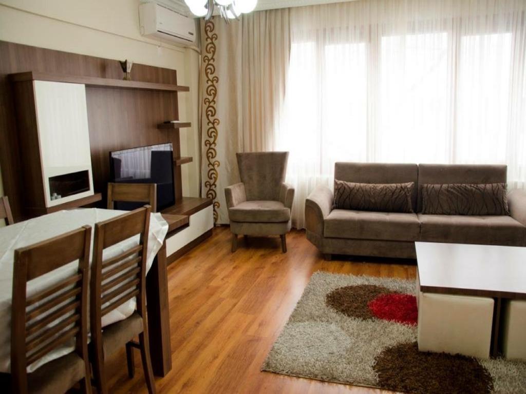 a living room with a couch and a table at Bedir Apartments in Istanbul