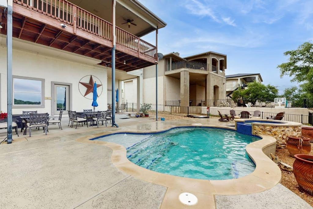 a swimming pool in the backyard of a house at Scenic Riverfront Home with Boat Access, Private Pool/Hot Tub - Close to Shopping in Lago Vista