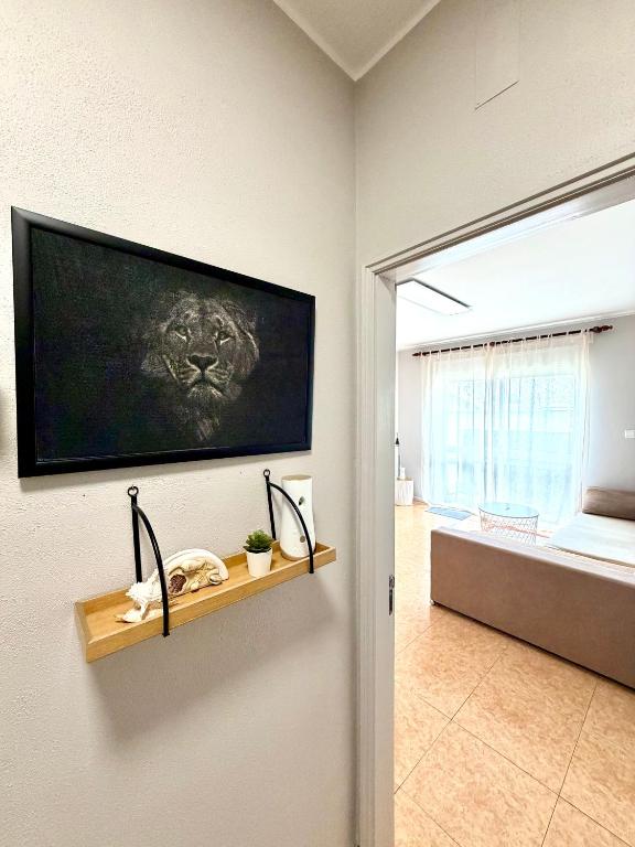 a living room with a television on a wall at DaKing in Vila do Conde