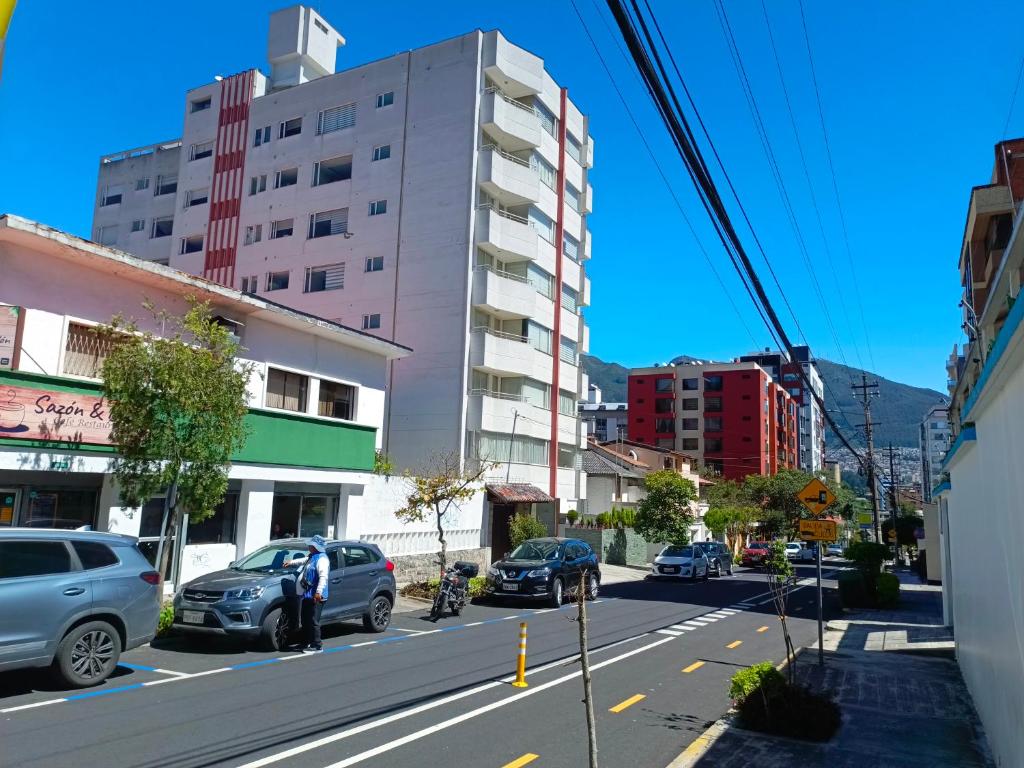 a city street with cars parked on the street at LIKE a HOME, 3Beds - Balcony - Garage - 6ThFloor in Quito