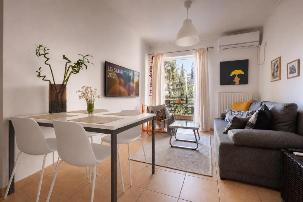 a living room with a table and chairs and a couch at Spartan Gem Apartment in Sparta