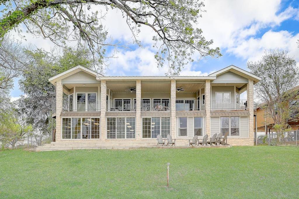 a large house with chairs in a yard at Lakeside, Dog-Friendly Living with Kayaks, Boat Ramp, Pool Table & Ping-Pong in Kingsland
