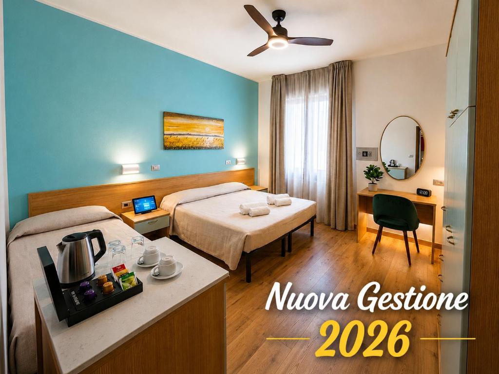 a hotel room with a bed and a desk at Hotel Pic Nic in Gatteo a Mare