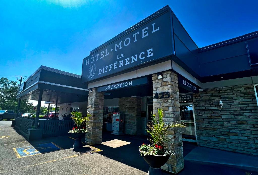 a store with a sign on the front of it at Hotel-Motel La Difference in Sainte-Marie