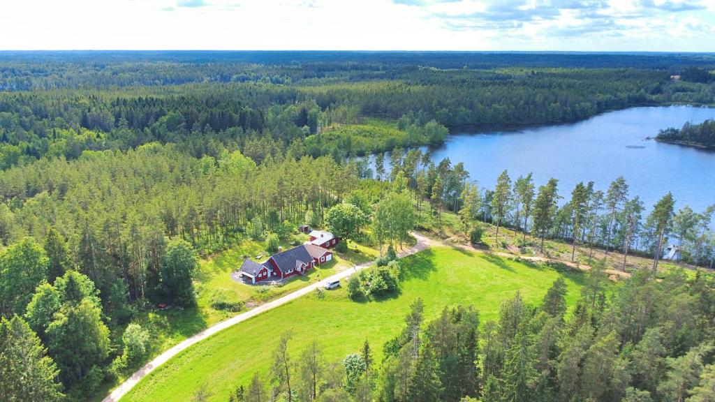 an aerial view of a house on a hill next to a lake at Villa Yasjö in Eringsboda
