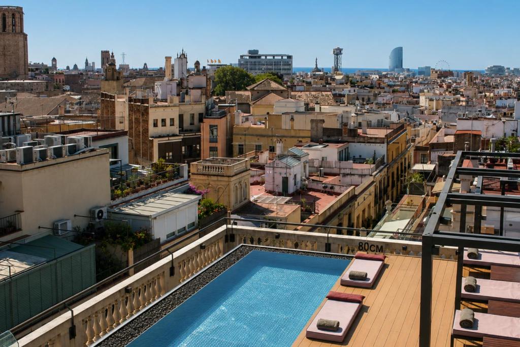 a view from the rooftop of a building with a swimming pool at Kimpton Vividora Hotel by IHG in Barcelona