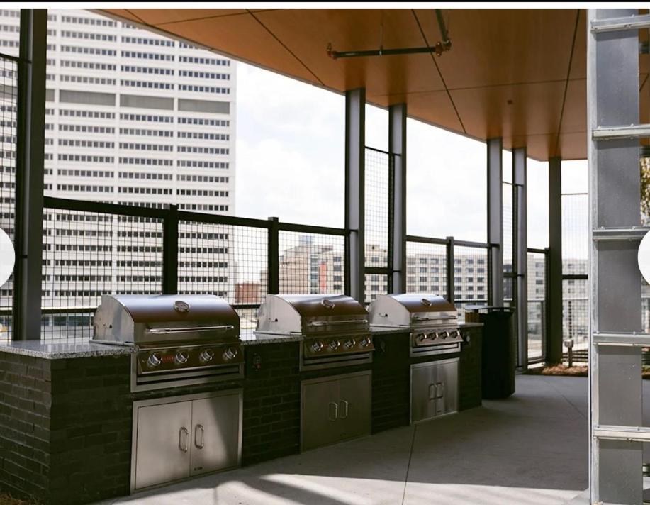 a kitchen with three stoves on a balcony with a view at Atl oasis in Atlanta