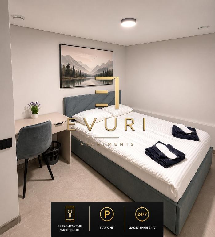 a bedroom with a bed and a desk with a sign on it at EVURI Rooms in Uzhhorod