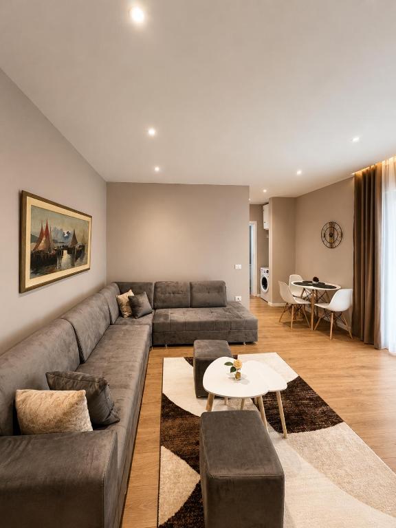 a living room with a couch and a table at ODA Central Stay in Elbasan